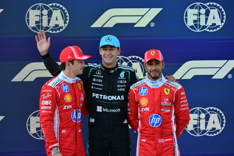British Mercedes driver George Russell stands between the Ferrari duo of Monaco's Charles Leclerc (left) and compatriot Lewis Hamilton after taking first place during qualifying for the Formula 1 Austrian Grand Prix. Spielberg on June 27, 2026