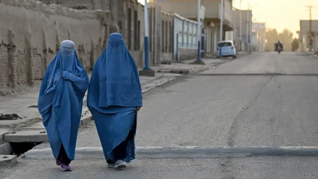 Afghan women wearing burqas walk on a street in Kandahar province, Afghanistan on August 25, 2026. 