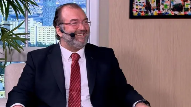 Jordanian journalist Dr. Salim Sharif sat on a chair during a television interview