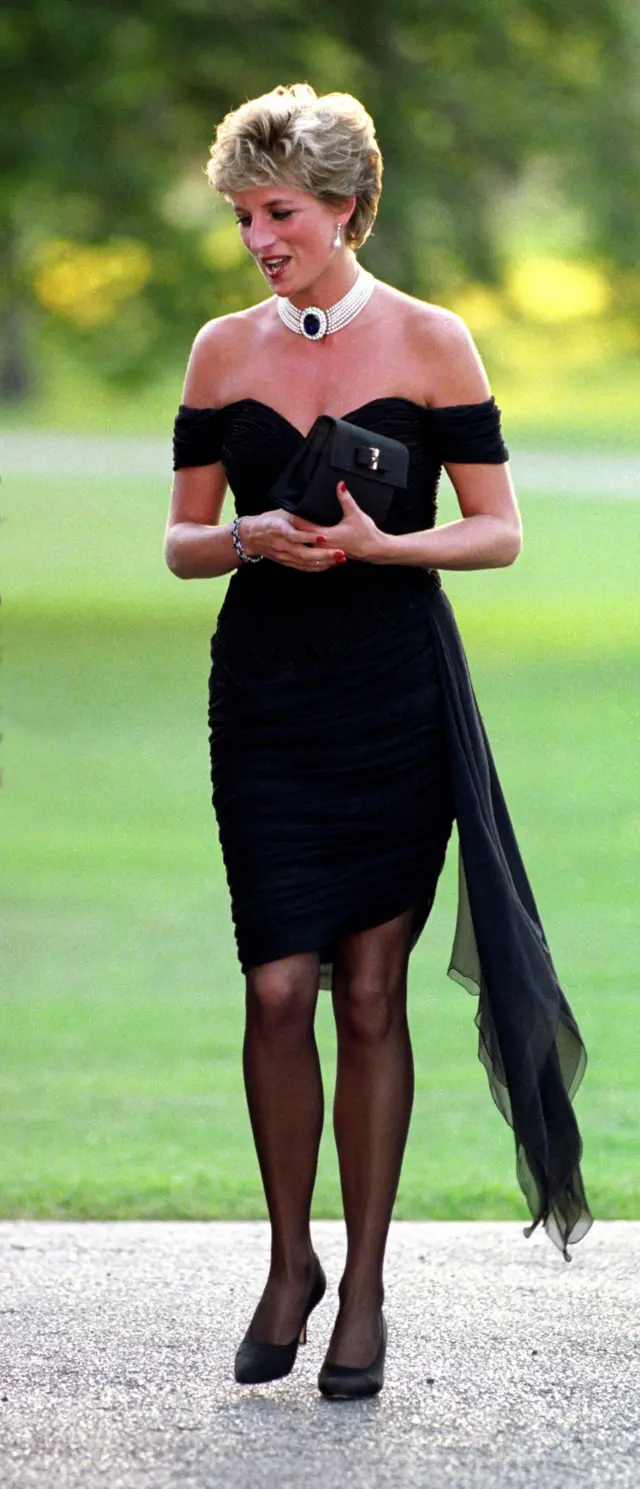 Princess Diana wore a black off-the-shoulder dress with a green grass back.