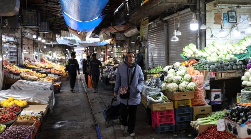 Economic pressures are reaching Iranians' desks, and the government is warning against protests