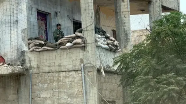 An Israeli soldier at a checkpoint near a residential building near the UNIFIL headquarters in Nakura, southern Lebanon
