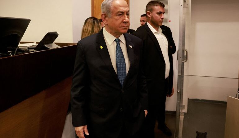 Rael's Prime Minister Benjamin Netanyahu enters the Tel Aviv District Court at the start of a hearing on corruption charges on December 10, 2024.